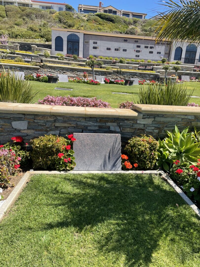 A garden with flowers and grass in the middle of it