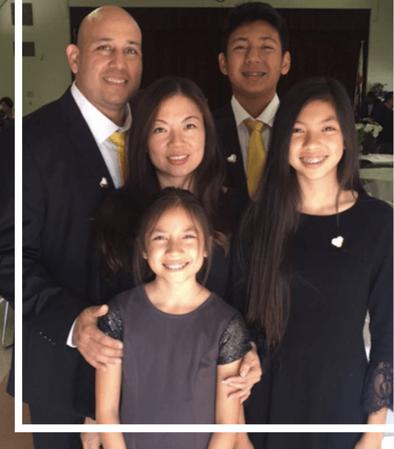 A family posing for a picture in formal wear.